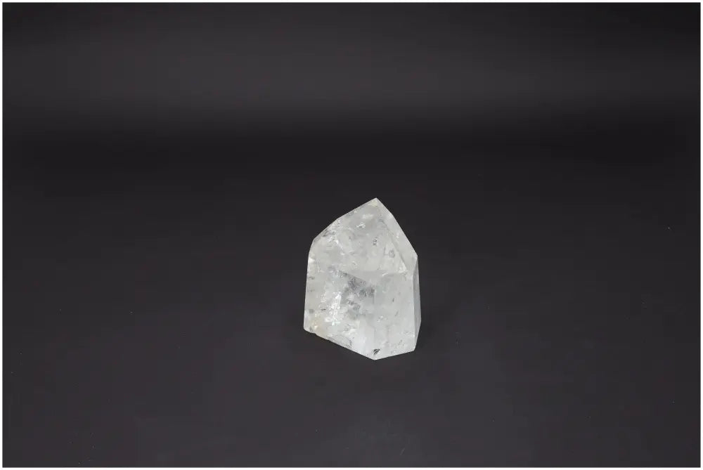 Lemurian Quartz Obelisk on a dark background, showcasing its clarity and elegance.
