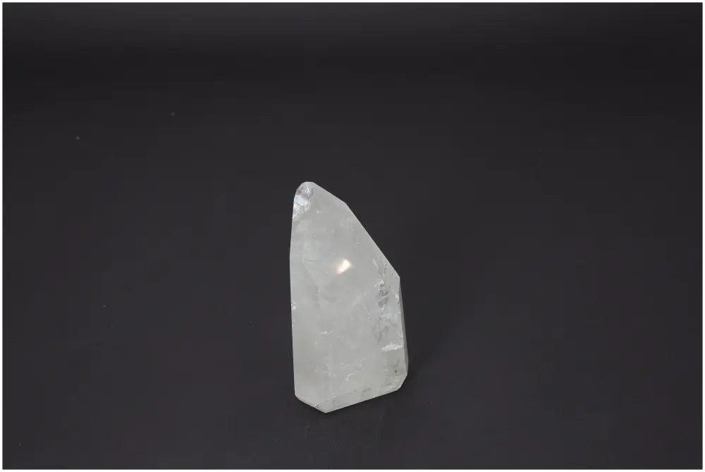 Lemurian Quartz Obelisk on black background, highlighting the crystal's clarity and elegance, part of Sylvia Crystals' luxury collection.