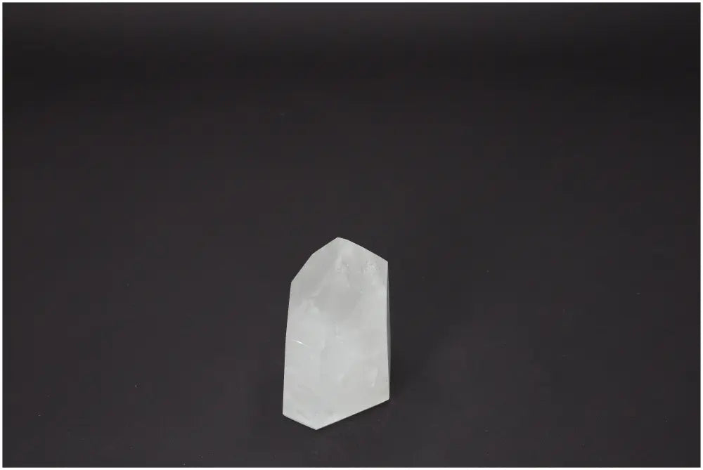 Lemurian Quartz Obelisk on dark background, premium gem from Sylvia Crystals collection, known for spiritual and purification properties.
