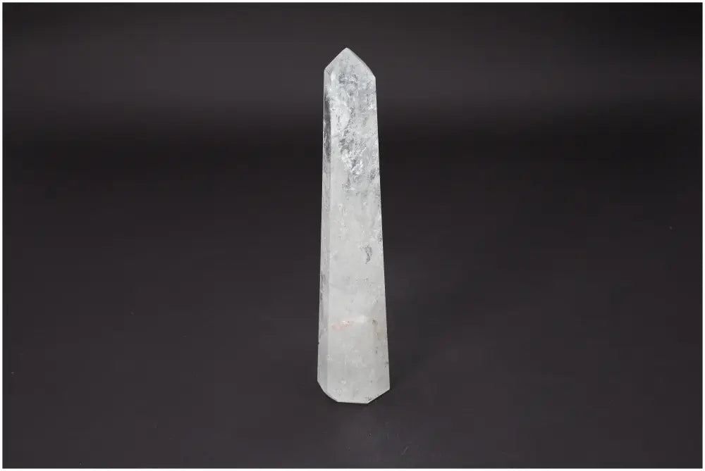 Lemurian Quartz Obelisk by Sylvia Crystals on black background, ideal for spiritual growth and energy purification, enhancing tranquility.