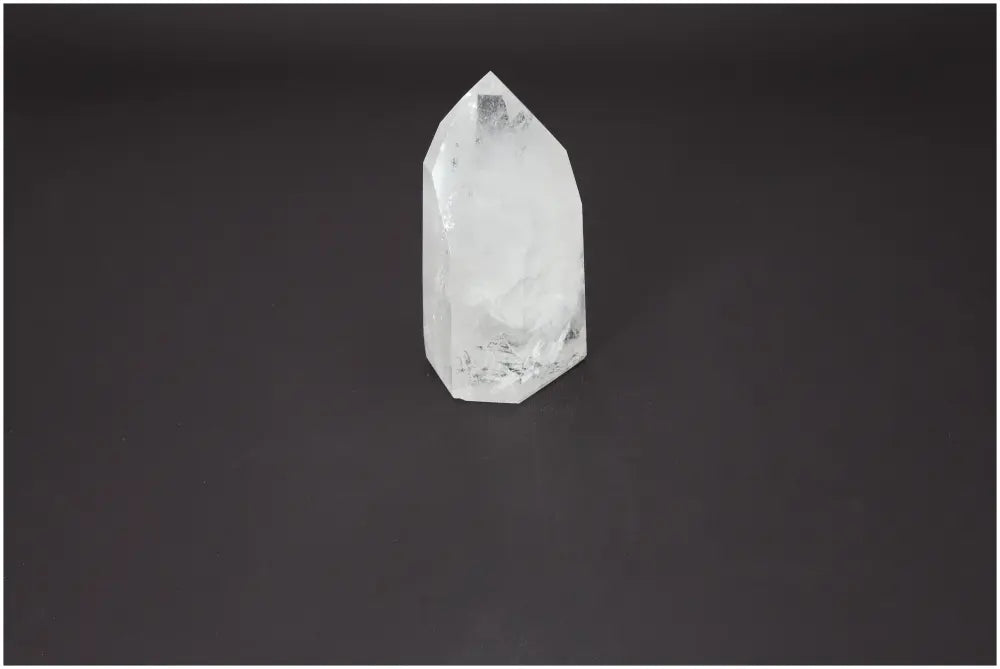 Lemurian Quartz Obelisk on dark background, premium crystal for spiritual enrichment and purification, from Sylvia Crystals.