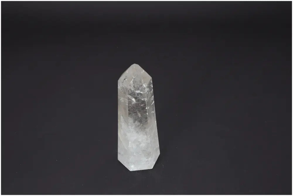 Lemurian Quartz Obelisk on a dark background, showcasing clear quartz properties and spiritual energy connections.