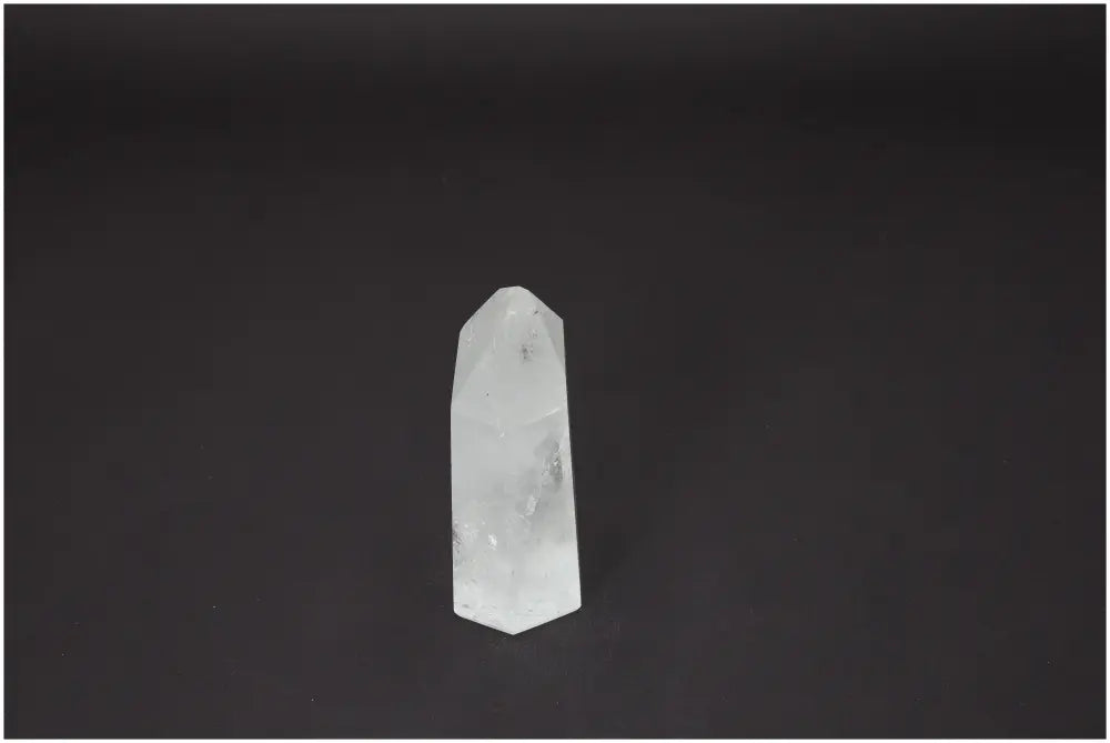 Lemurian Quartz Obelisk on a black background, known for chakra balancing and energetic healing properties.