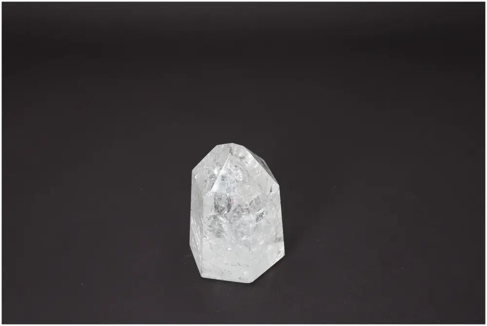 Lemurian Quartz Obelisk on black background, showcasing unique clarity and chakra properties for spiritual enhancement.