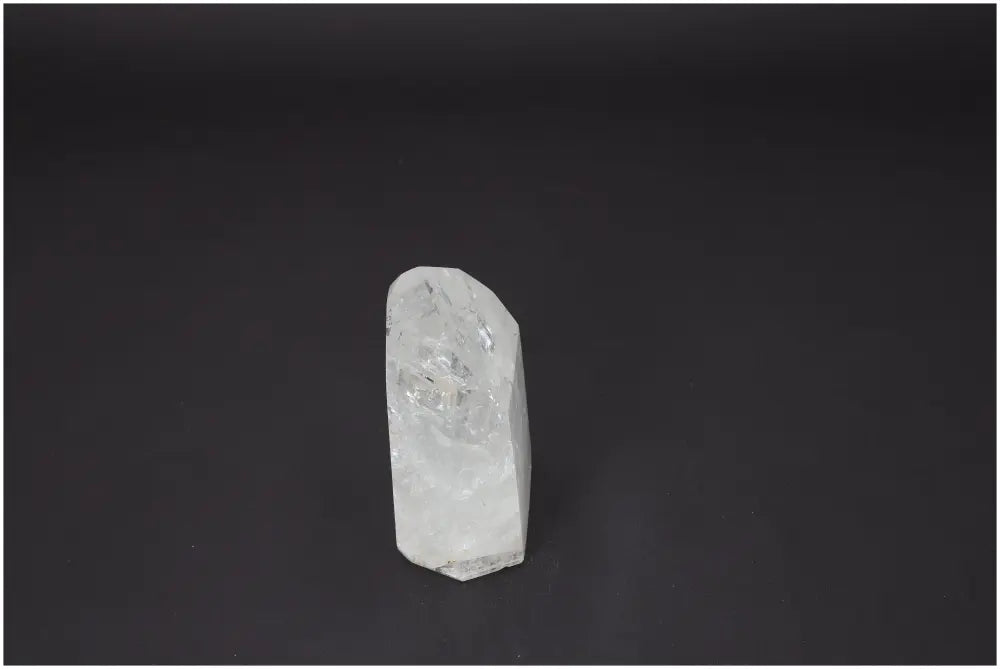 Lemurian Quartz Obelisk on dark background, showcasing its unique crystalline structure for chakra and zodiac energy alignment.