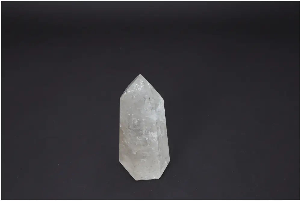 Lemurian Quartz Obelisk on black background, known for its unique properties and chakra alignment, enhancing spiritual and energetic well-being.