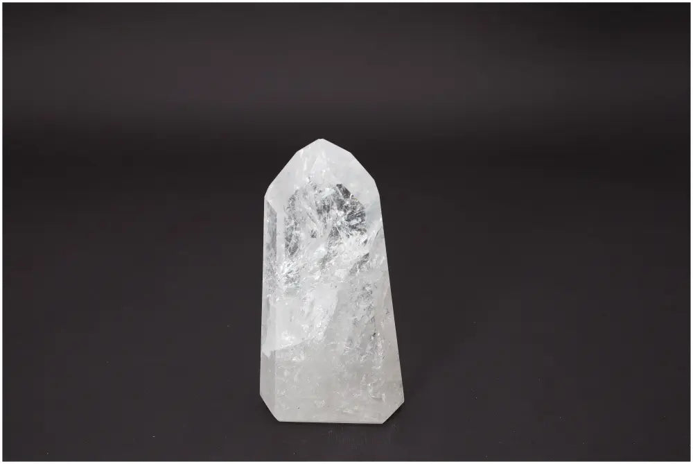 Lemurian Quartz Obelisk on black background, showcasing its clear crystalline structure for chakra and zodiac energy alignment.