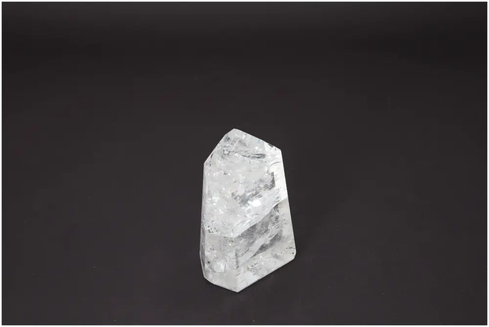 Lemurian Quartz Obelisk against a dark background, known for its unique properties and chakra alignment benefits.