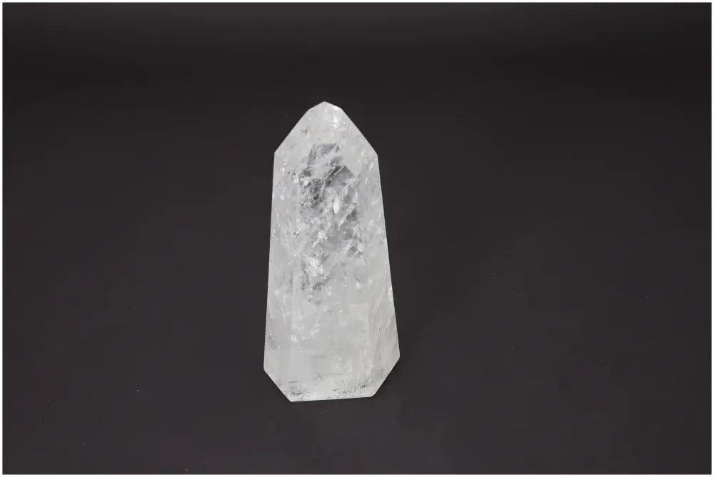 Lemurian Quartz Obelisk on dark background, a crystal with properties linked to chakras and zodiac signs, enhancing energy and spirit.