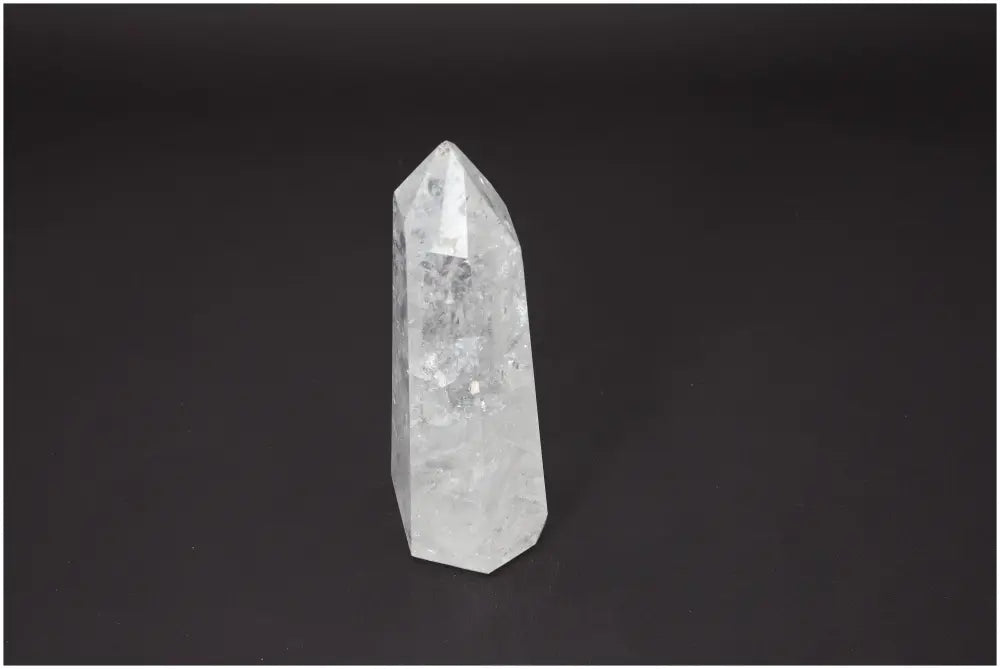 Lemurian Quartz Obelisk with unique properties, enhances chakra alignment, supports spiritual needs, on a dark background.