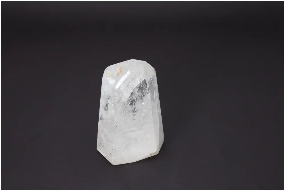 Lemurian Quartz Obelisk against black background, showcasing unique spiritual properties and chakra associations.