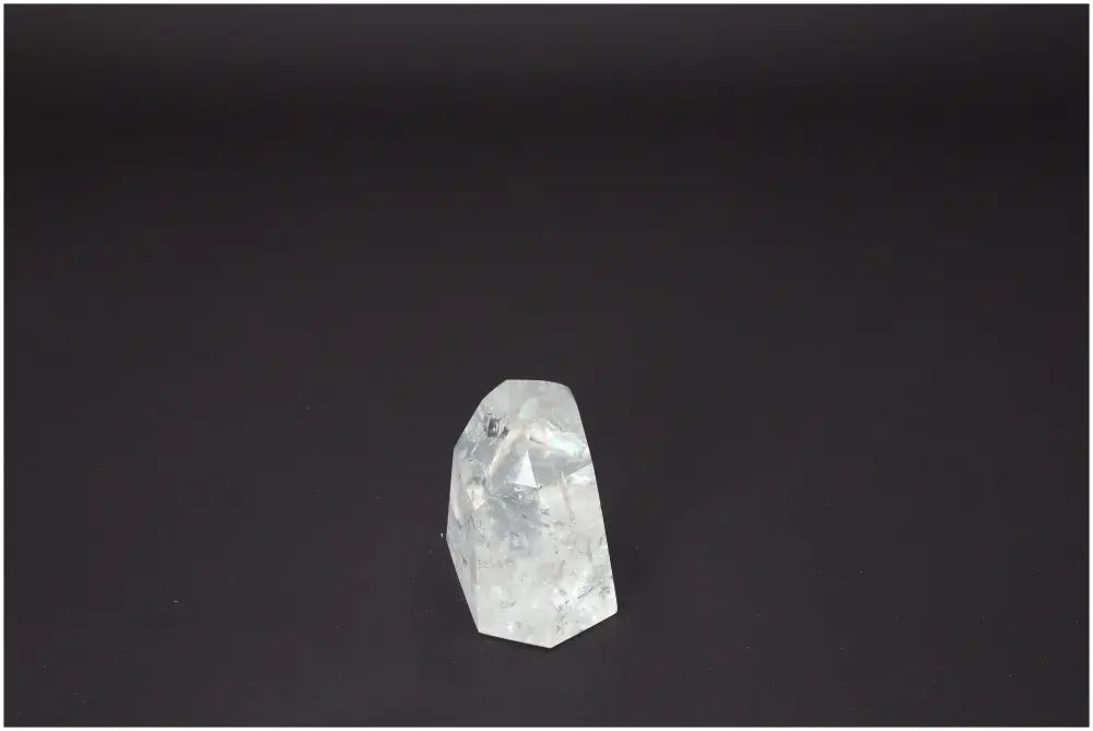 Lemurian Quartz Obelisk with unique spiritual properties, associated with various chakras and zodiac signs on a black background.