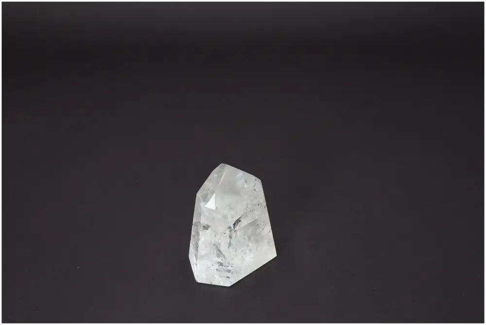 Lemurian Quartz Obelisk on black background, showcasing unique crystal facets for chakra healing and spiritual energy.