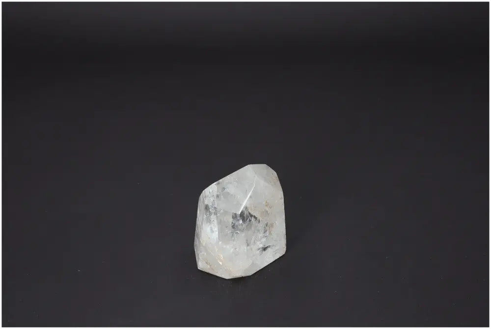 Lemurian Quartz Obelisk on dark background showcasing natural clarity and energetic properties for chakra and zodiac alignment.