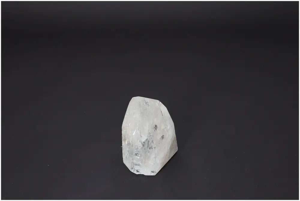 Lemurian Quartz Obelisk on black background, highlighting its natural clarity and spiritual properties for chakra healing and zodiac alignment.