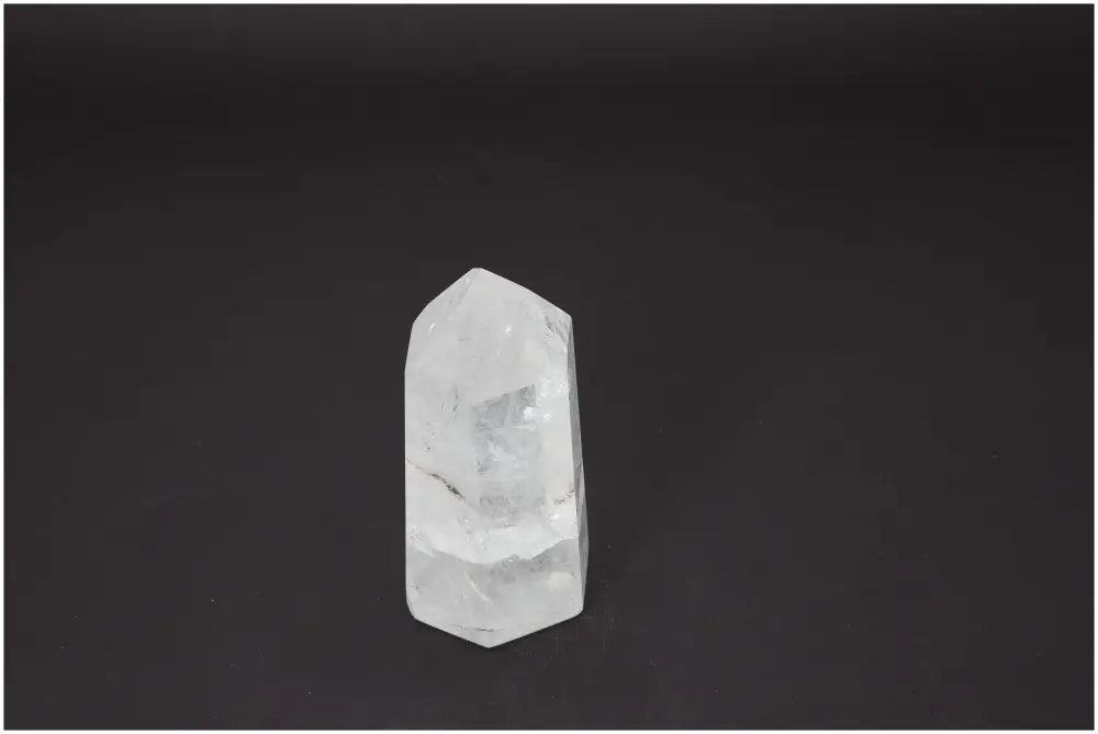 Lemurian Quartz Obelisk placed against a dark background, showcasing its natural crystal clarity and spiritual properties.