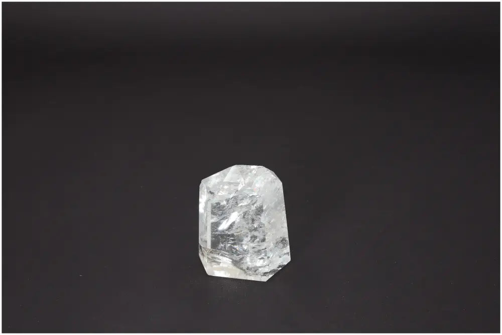 Lemurian Quartz Obelisk against a dark backdrop, showcasing its clear crystalline structure and unique energetic properties