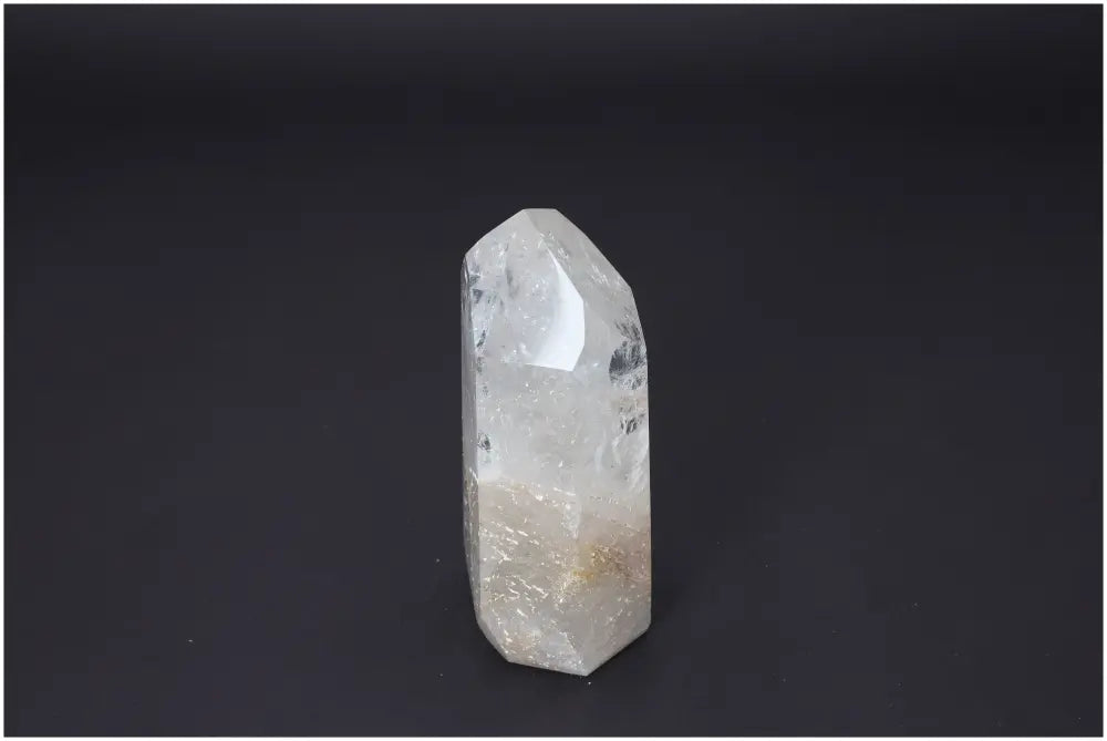 Lemurian Quartz Obelisk against dark background, showcasing unique color and energetic properties aligned with chakras and zodiac signs.