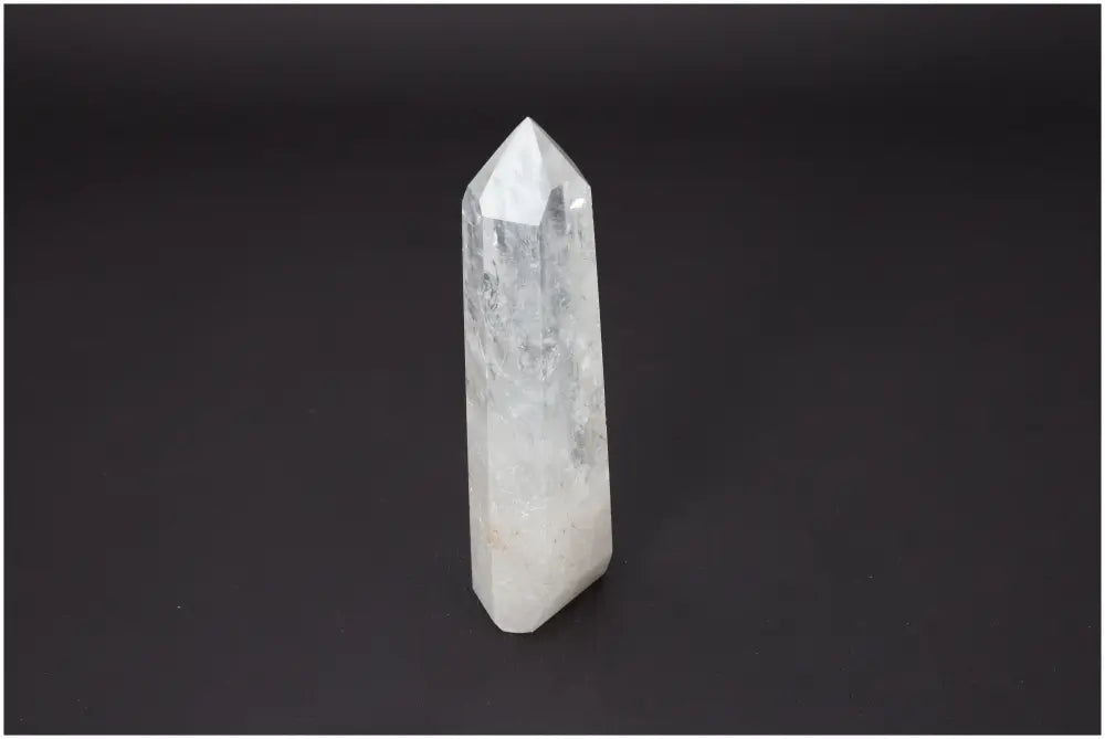 Lemurian Quartz Obelisk on black background, showcasing its unique energetic properties and spiritual significance for chakras.
