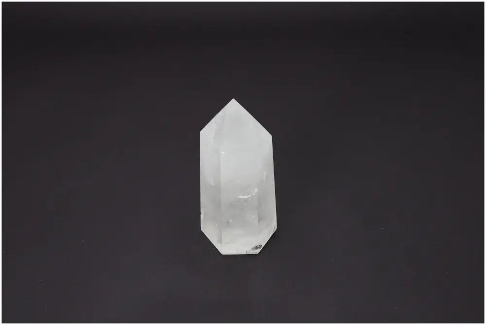 Lemurian Quartz Obelisk on dark background, showcasing its unique properties and connection to chakras and zodiac signs.