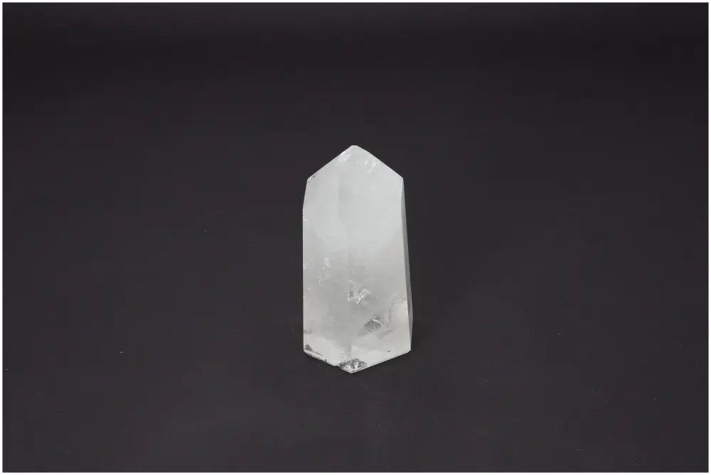 Lemurian Quartz Obelisk on dark background, showcasing its unique spiritual properties for chakras and zodiac signs.