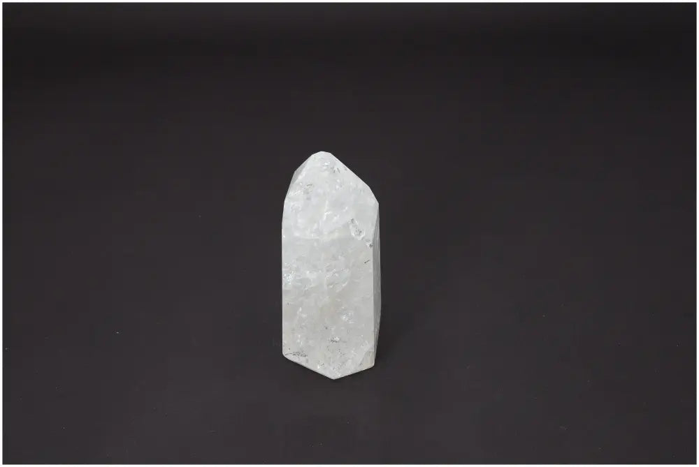 Lemurian Quartz Obelisk on black background, showcasing its spiritual properties and quartz variety for chakra and zodiac alignment.