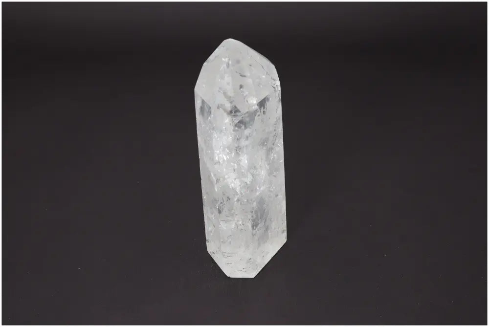 Lemurian Quartz Obelisk showcasing unique crystal properties for chakra and zodiac energy alignment on dark background.