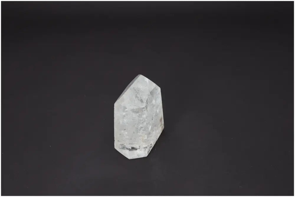 Lemurian Quartz Obelisk supporting chakras and zodiac signs against dark background.