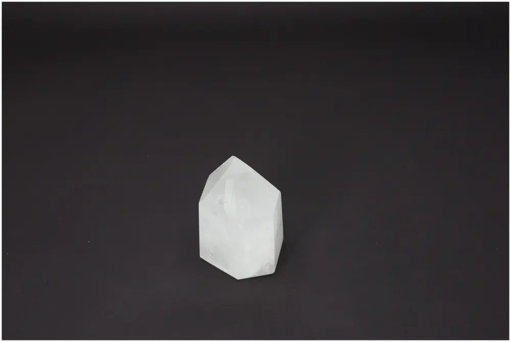 Lemurian Quartz Obelisk on black background, a gemstone with unique spiritual and energetic properties, linked to chakras and zodiac signs.