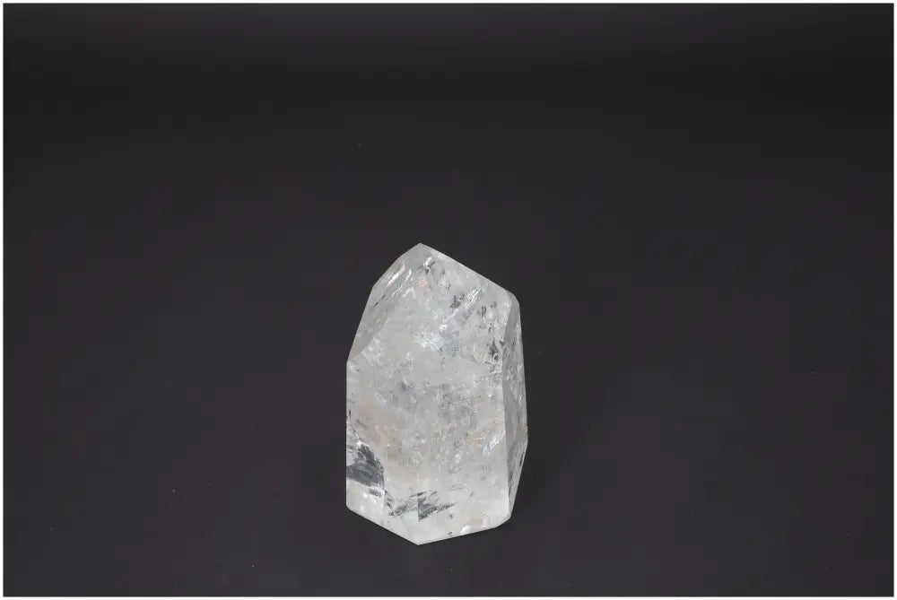 Lemurian Quartz Obelisk displayed on a dark background, showcasing its natural crystal clarity and unique energetic properties.
