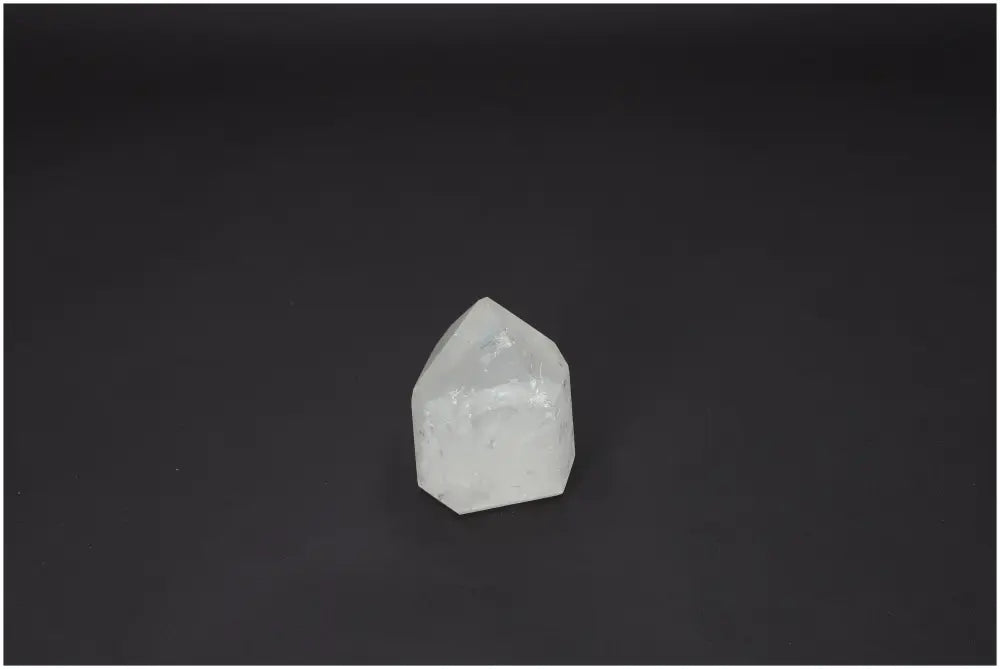 Lemurian Quartz Obelisk on a dark background showcasing its natural clarity and spiritual properties.