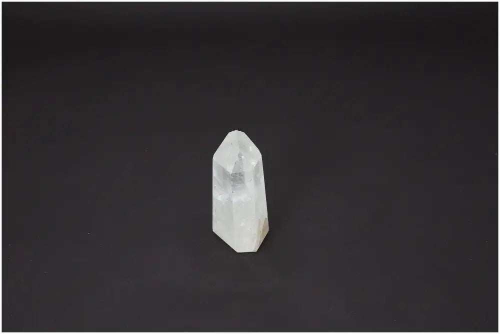 Lemurian Quartz Obelisk on black background, showcasing unique properties for chakra alignment and spiritual healing.