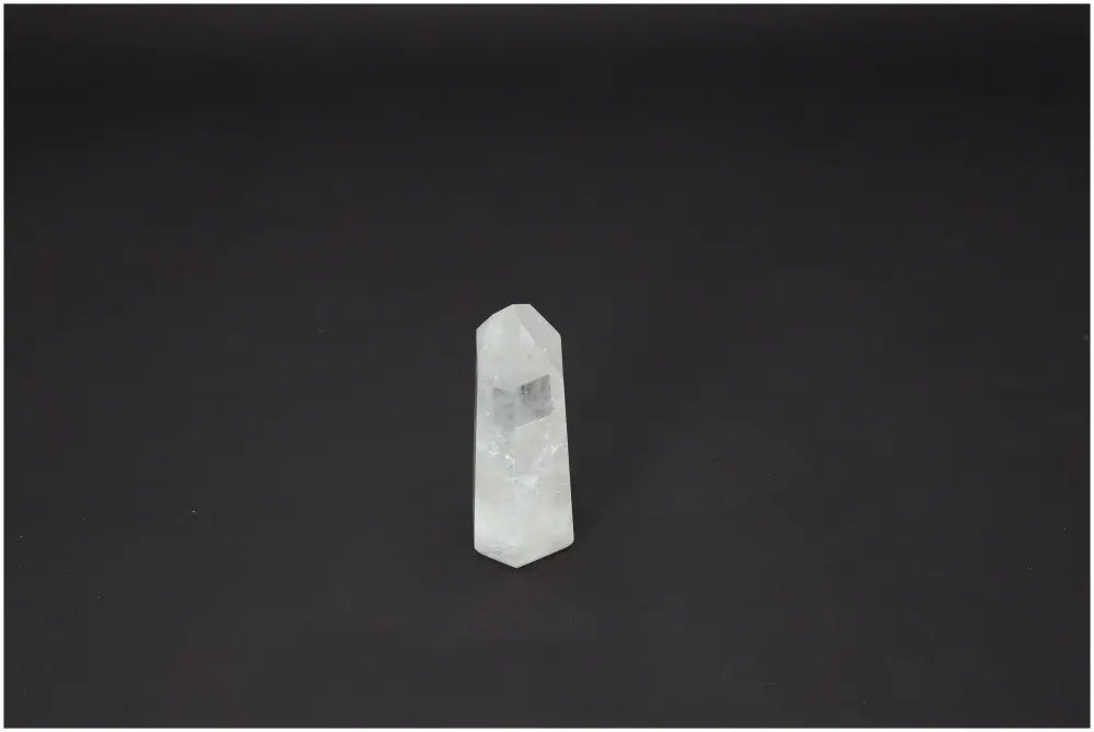 Lemurian Quartz Obelisk on dark background, showcasing its clear crystal structure and unique energetic properties.