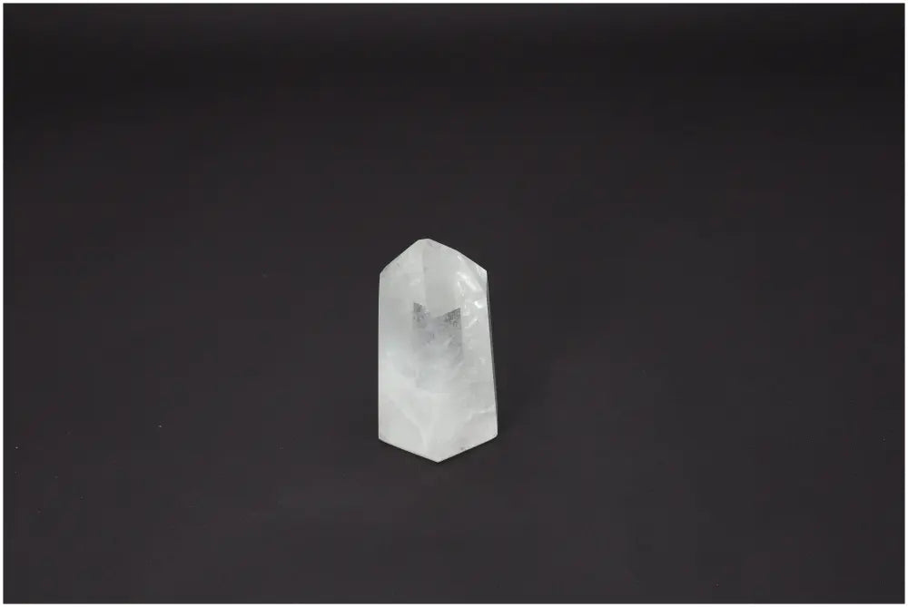 Lemurian Quartz Obelisk on dark background, showcasing its unique properties related to chakras and zodiac signs.