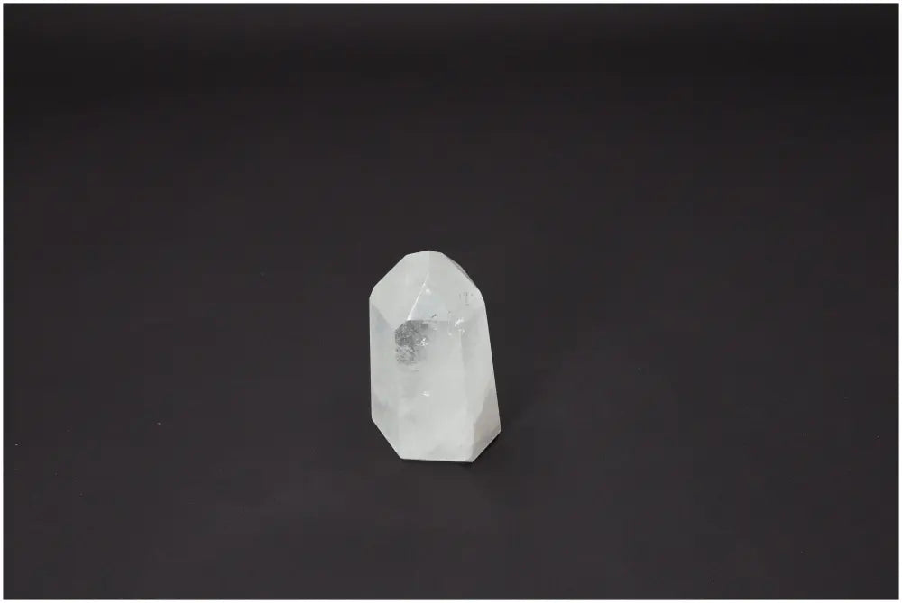 Lemurian Quartz Obelisk on dark background representing chakra and zodiac energy properties.