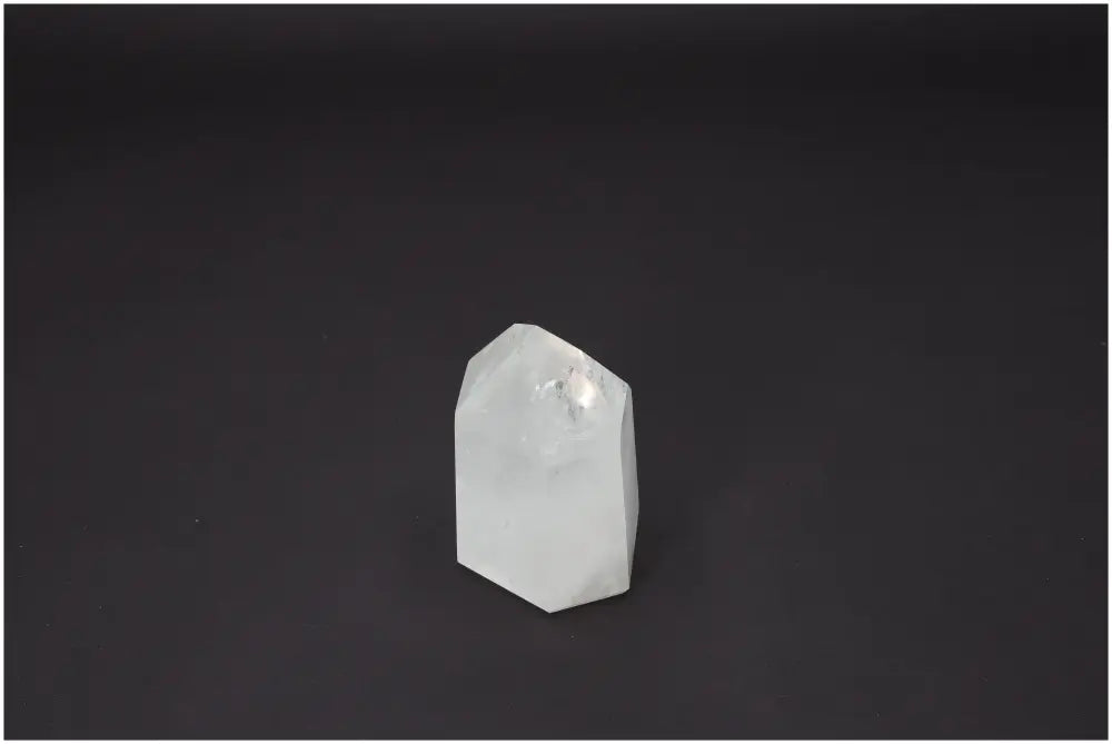 Lemurian Quartz Obelisk on dark background showcasing its unique energetic properties and spiritual benefits for chakras and zodiac signs.