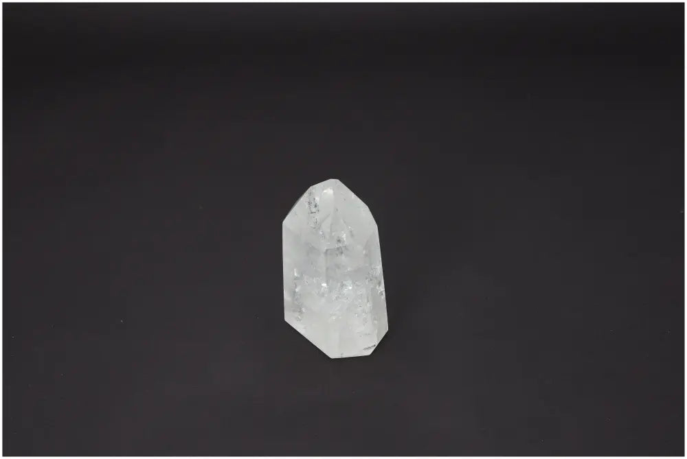 Lemurian Quartz Obelisk on dark background, enhances energetic and spiritual needs, supports chakras, various quartz properties.