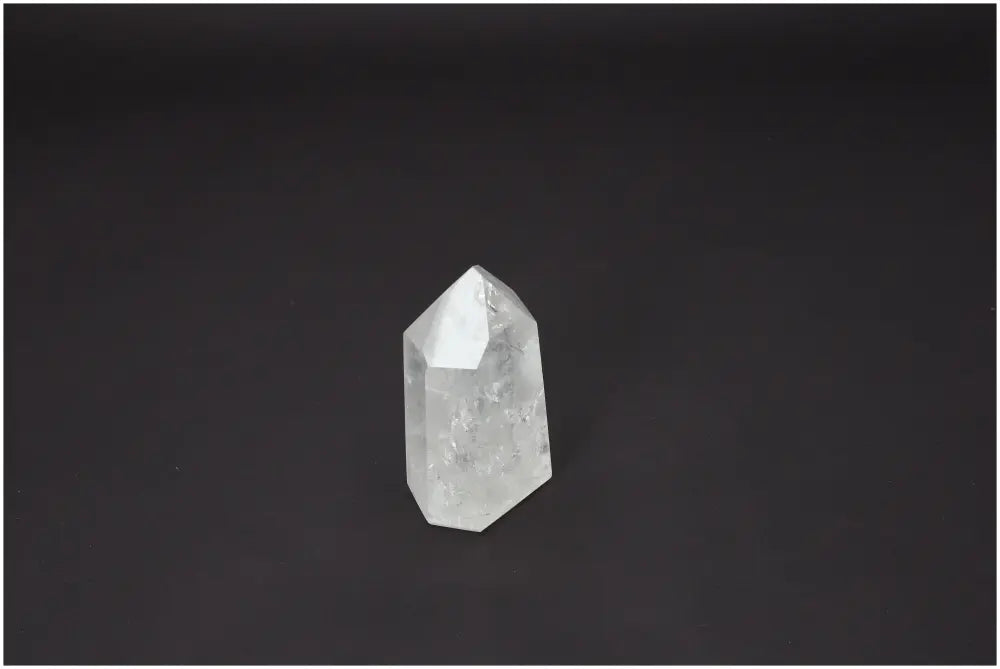 Lemurian Quartz Obelisk on black background, showcasing its crystalline structure and spiritual properties.