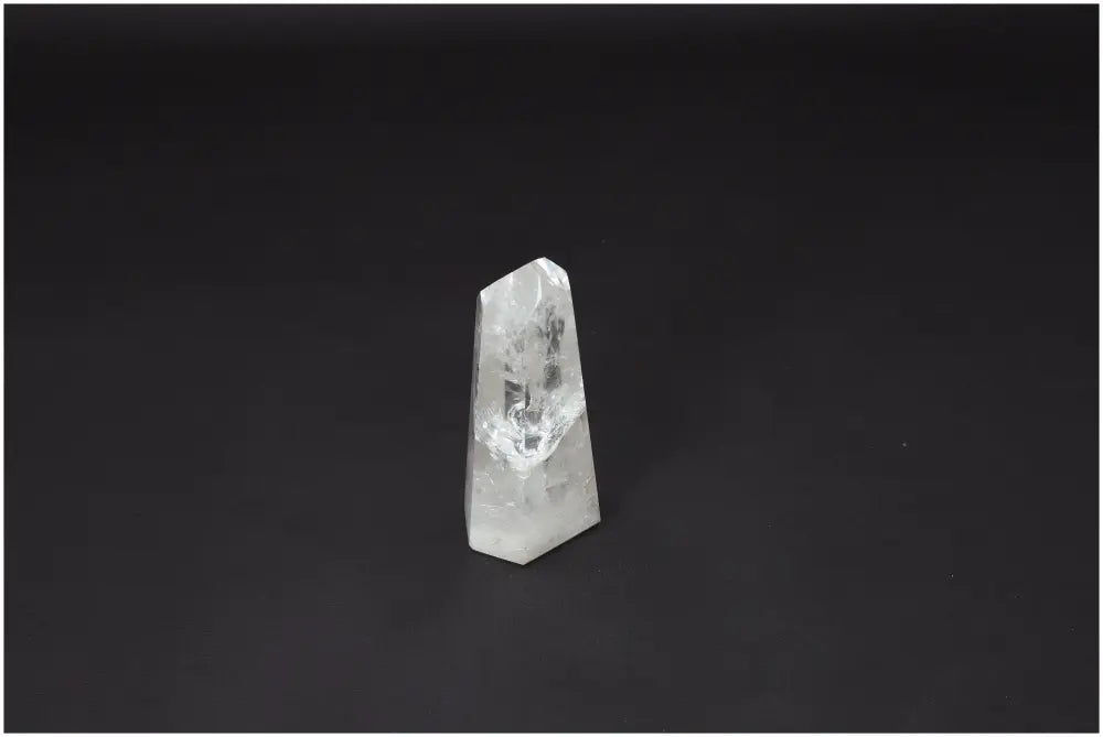Lemurian Quartz Obelisk on black background, showcasing its unique crystal structure and spiritual properties, associated with chakras.