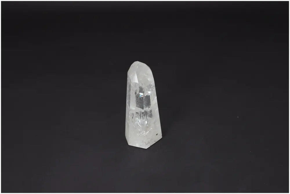 Lemurian Quartz Obelisk for energizing chakras, spiritual healing, and enhancing zodiac connections, set against a dark background.