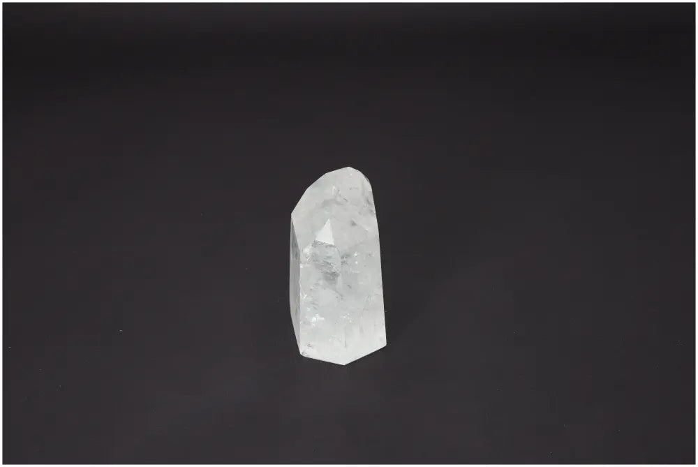 Lemurian Quartz Obelisk against a dark background, showcasing its clarity and spiritual properties.