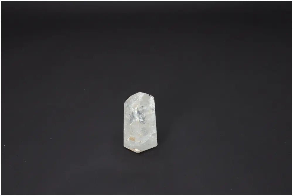 Lemurian Quartz Obelisk with unique quartz properties enhancing chakras and spiritual energy on black background.