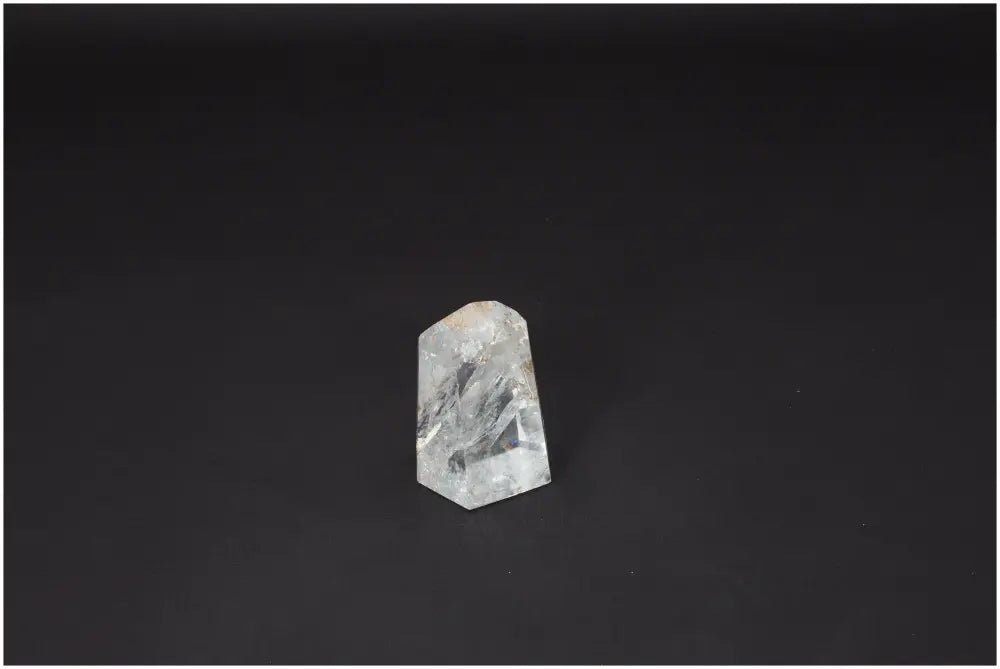 Lemurian Quartz Obelisk on dark background, enhancing chakras and spiritual needs with unique energetic properties.