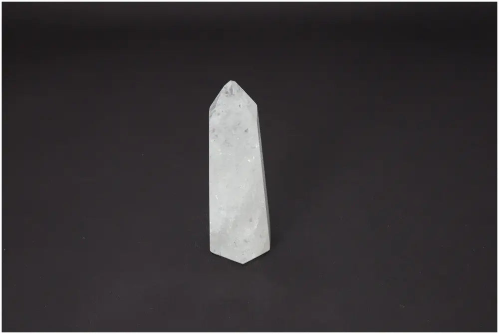 Lemurian Quartz Obelisk for chakra and zodiac energy, spiritual healing, and body balance on a dark background.