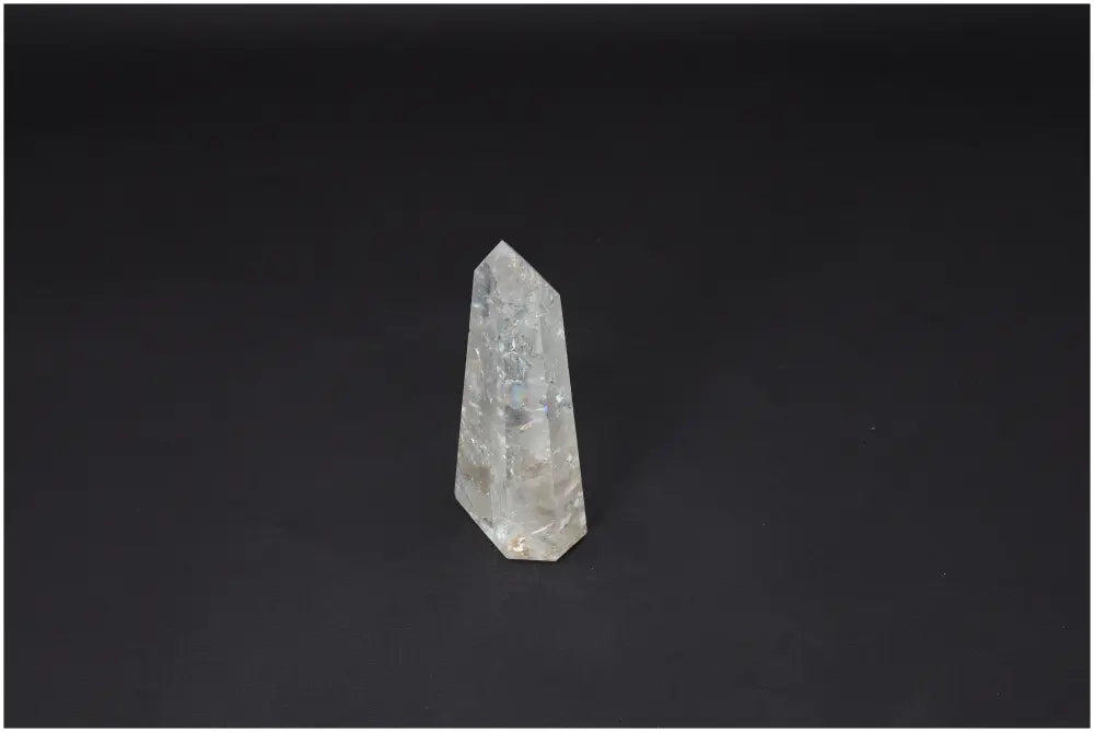 Lemurian Quartz Obelisk with unique properties, linked to chakras and zodiac signs, displayed against a dark background.