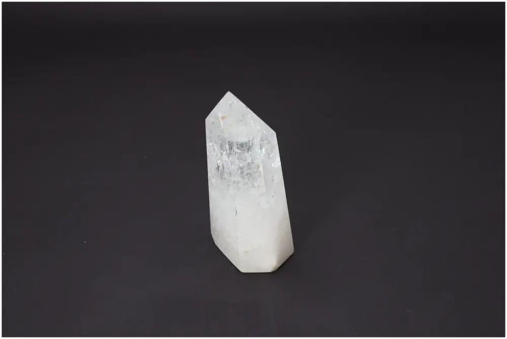 Lemurian Quartz Obelisk on black background, highlighting its clear facets and natural energy properties for chakras and zodiac balance.