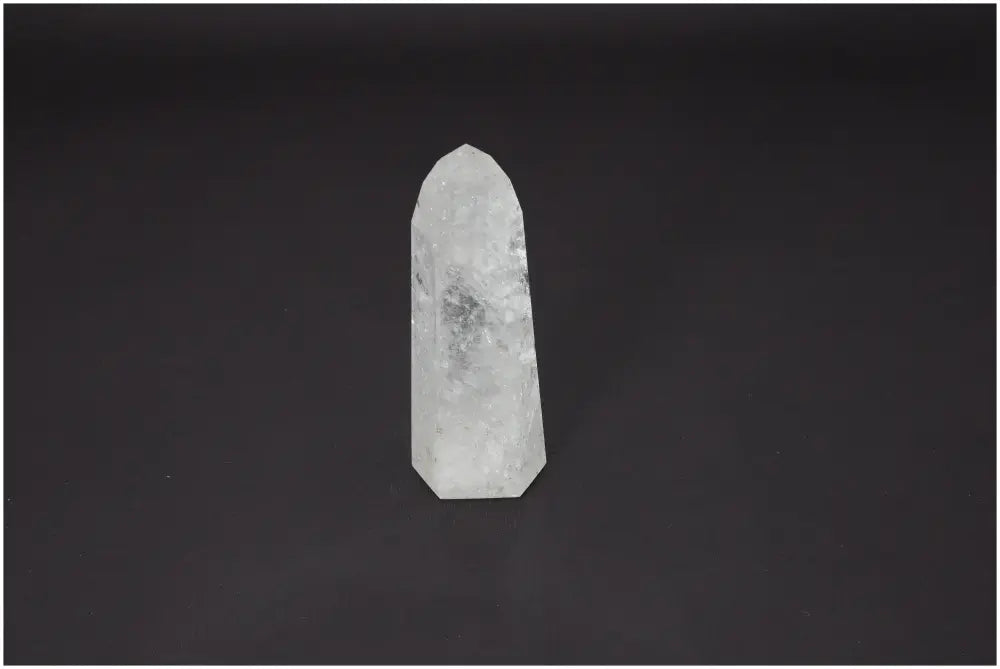 Lemurian Quartz Obelisk crystal with unique chakra and zodiac properties for spiritual and energetic support against a dark background.