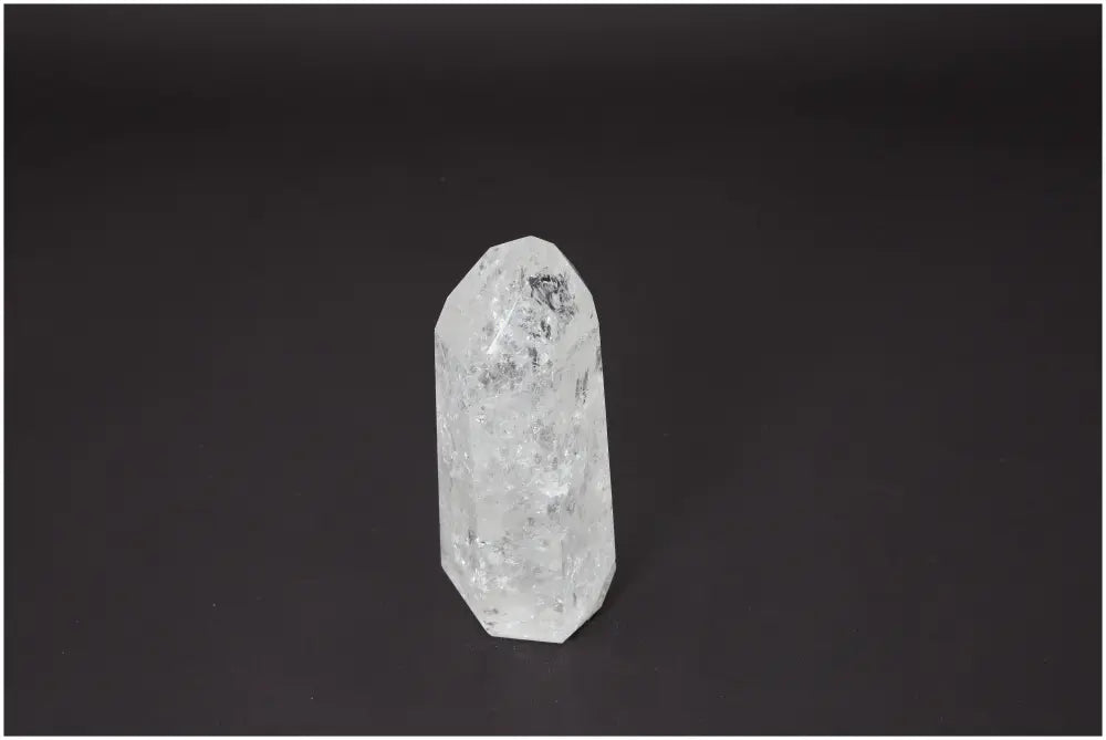 Lemurian Quartz Obelisk on dark background, known for its unique energetic properties linked to chakras and zodiac signs, enhancing harmony.