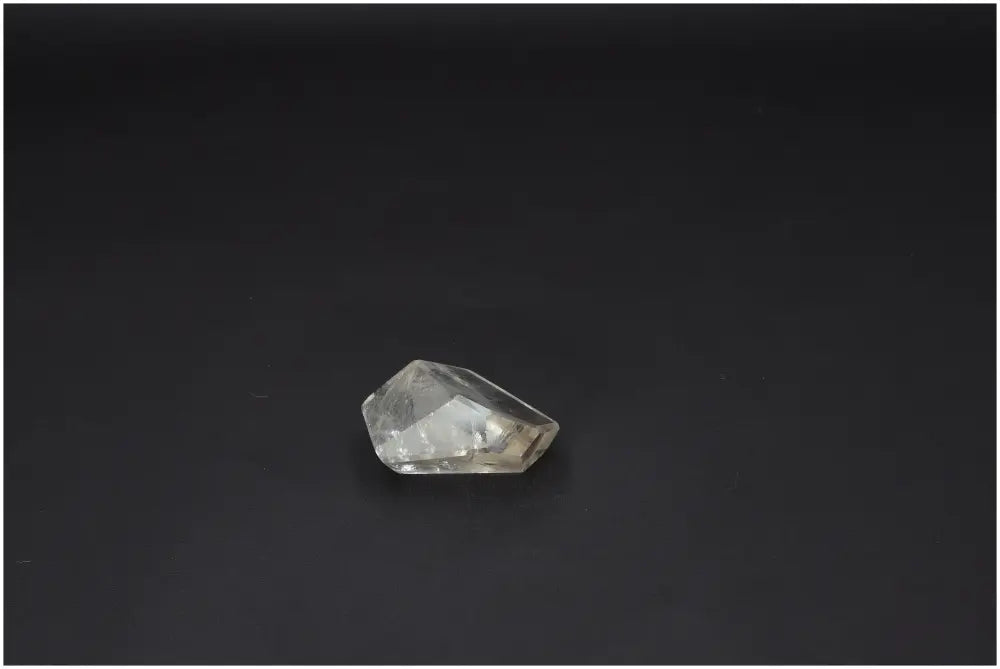 Lemurian Quartz Obelisk against a dark background, showcasing clarity and spiritual properties connected to chakras and zodiac signs.