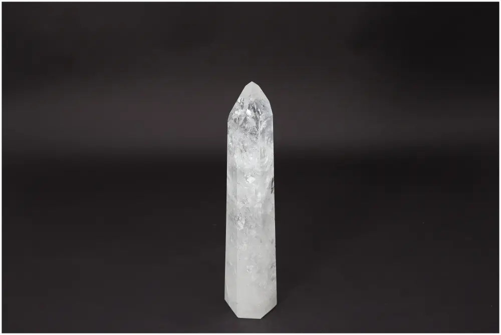 Lemurian Quartz Obelisk crystal for clarity and balance on black background, promotes energy amplification and personal growth.